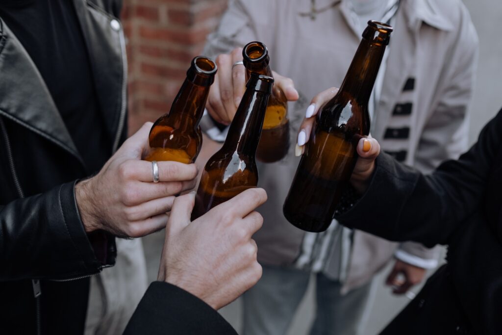 quatres amis trinquent bouteilles bières artisanales